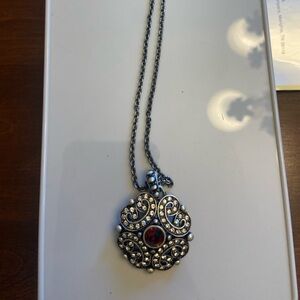 Touchstone Crystal necklace with red crystal in middle.